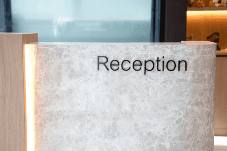 Bespoke curved commercial reception desk with premium laminated surfaces